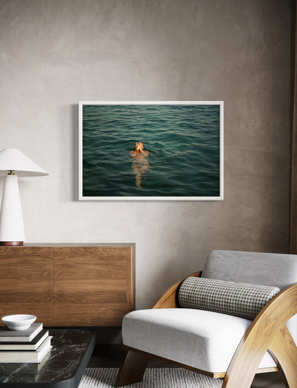 Framed artwork of a person swimming in water above a modern living room setting.